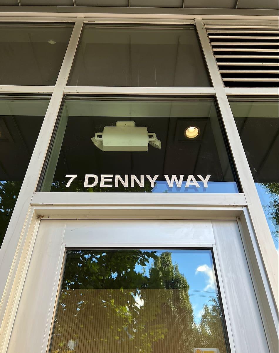 Entrance sign reading 7 Denny Way at the new home of Liana Hair Salon in Seattle