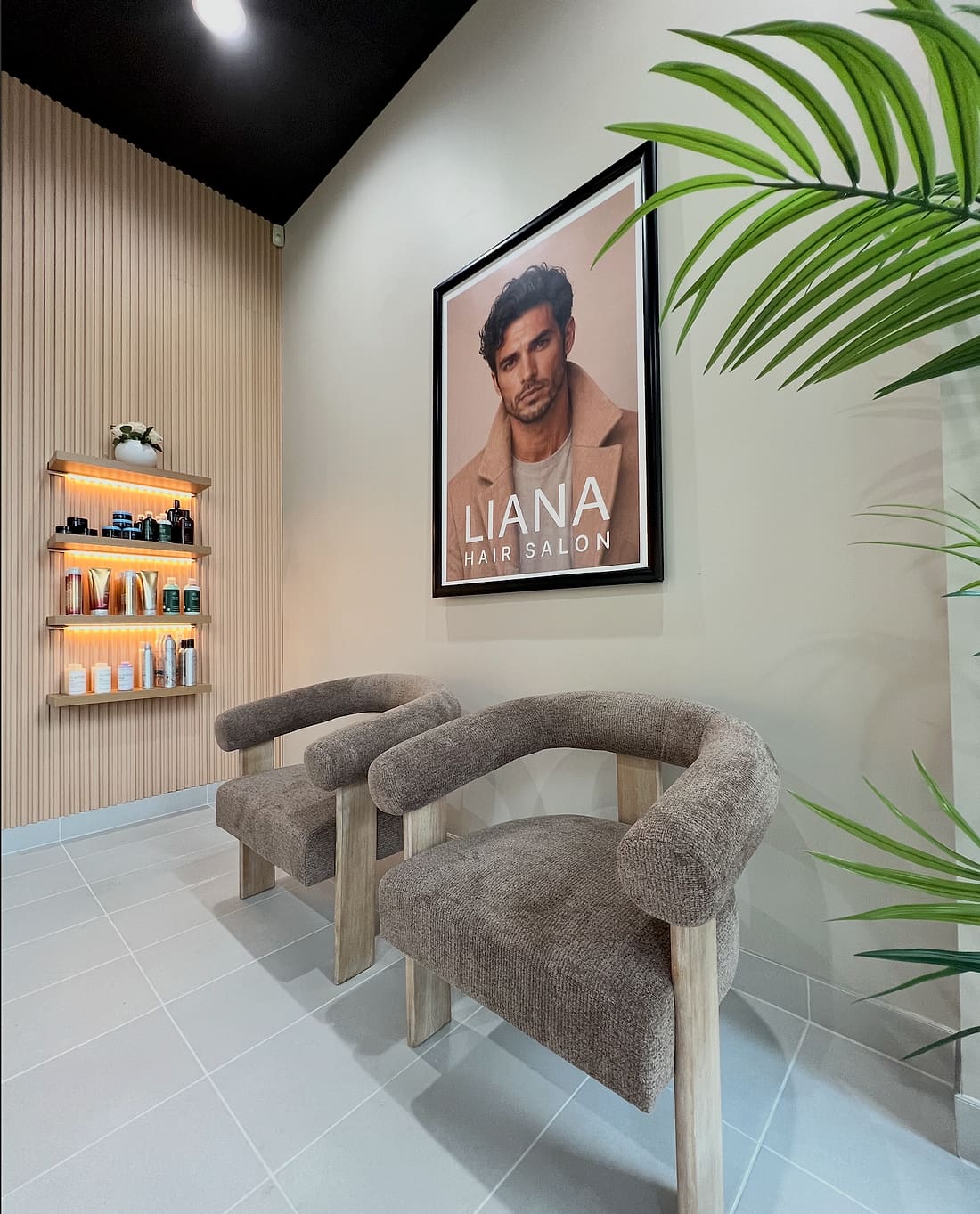 Boucle armchairs and product shelf in the waiting area of Liana Hair Salon, Seattle